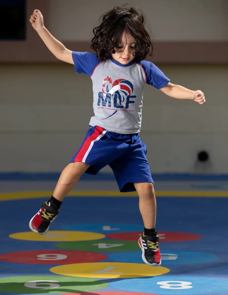 LFIB student jumping in the sports hall over numbered colour circles